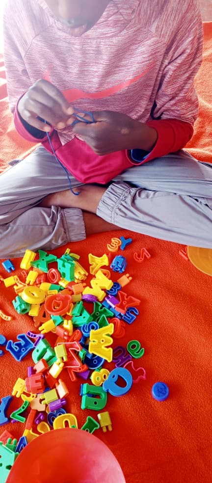 Child working on fine motor skills with educational materials